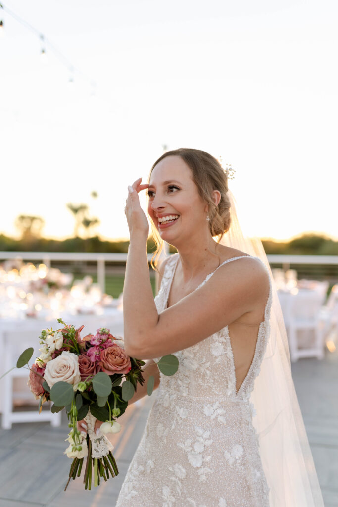 Arizona cis-het wedding at Mountain Shadows Resort bride smiling with flowers