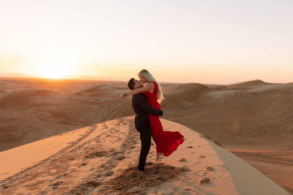 Formal couple kissing in the sand dunes