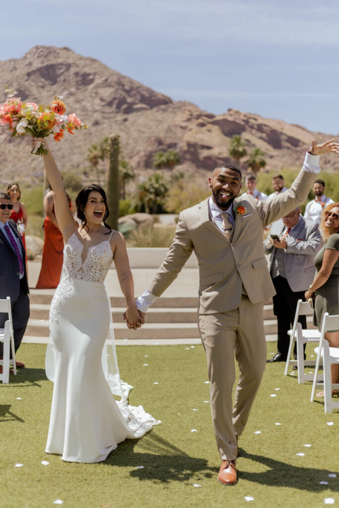 Bride and groom celebrate their ceremony exit in style at Mountain Shadows Resort in Scottsdale, Arizona