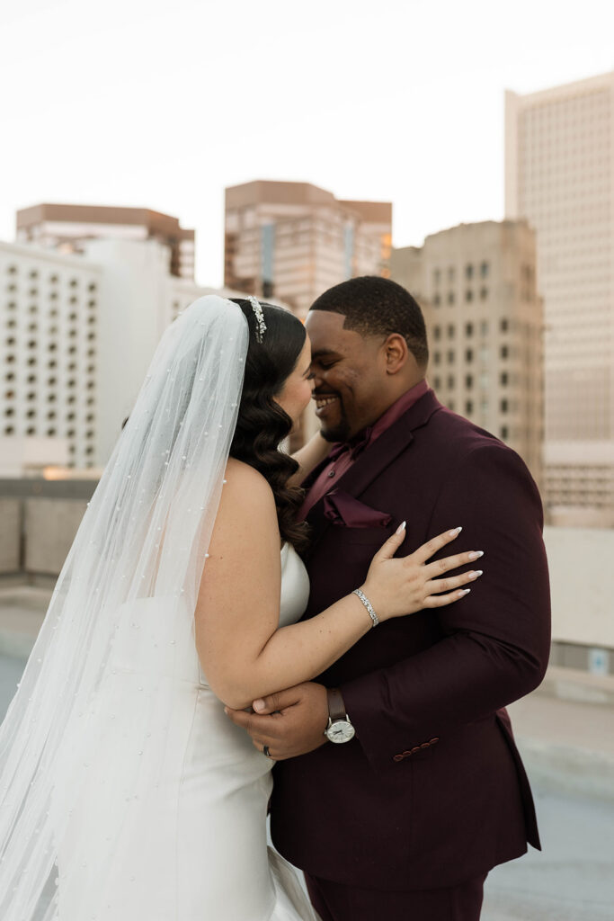 Latina bride and black groom closely laughing in Phoenix Arizona