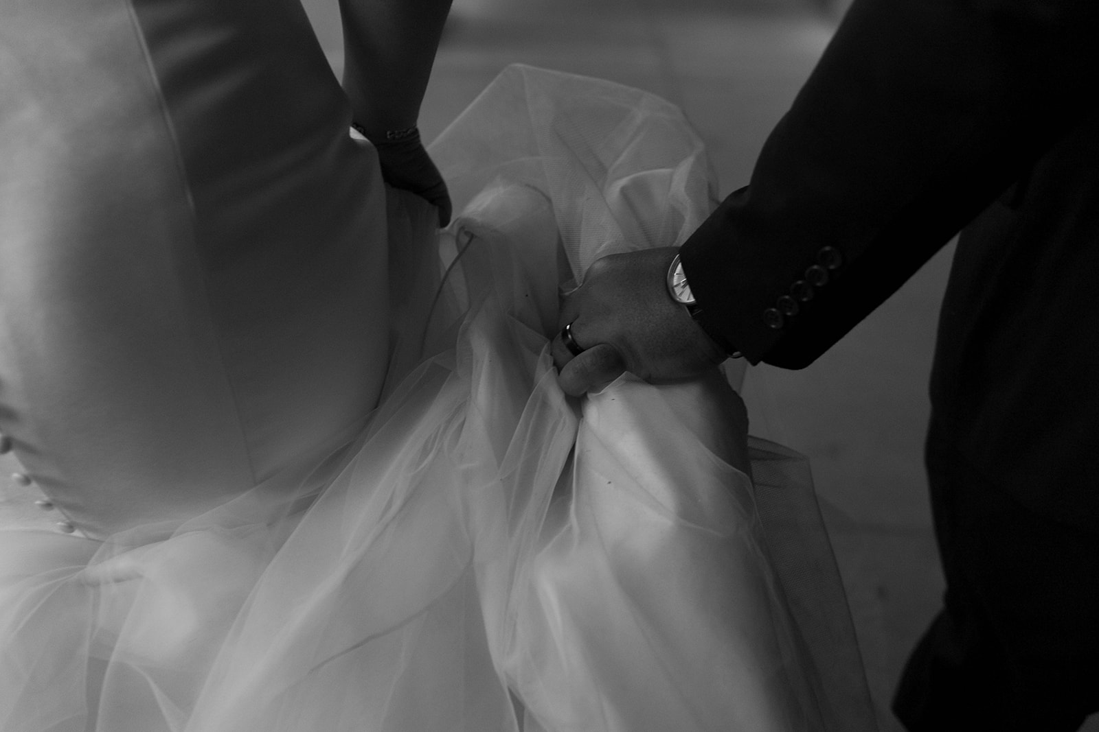Couple walking with groom holding bride's dress in Phoenix, Arizona