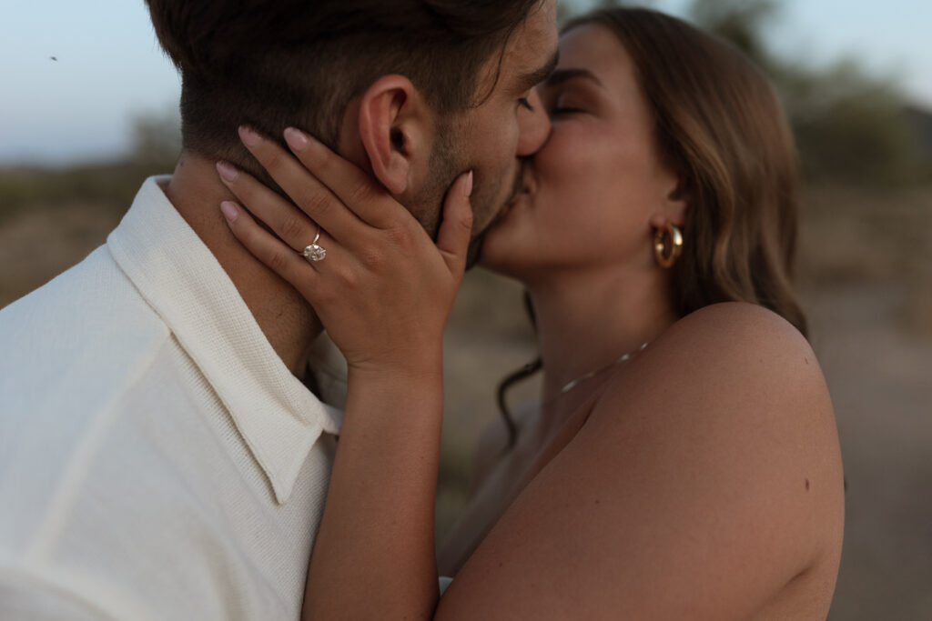 Gorgeous diamond engagement ring featured on real couple kissing in the desert