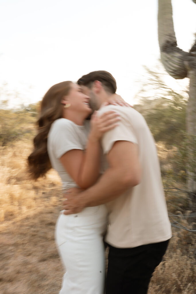 Engaged couple dancing in the desert